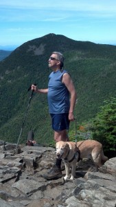 Randy Pierce & guide dog Quinn on top of mountain